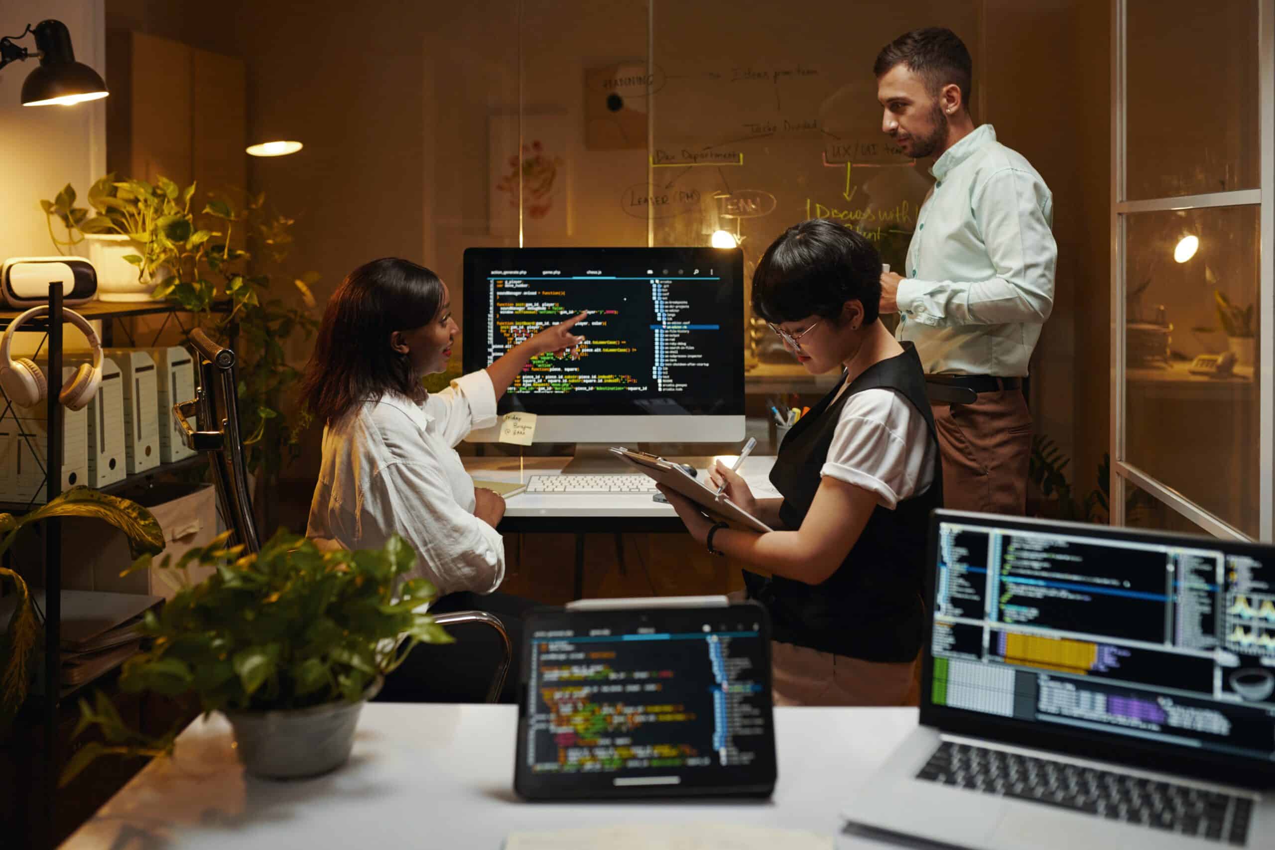 Group of developers working on programming code